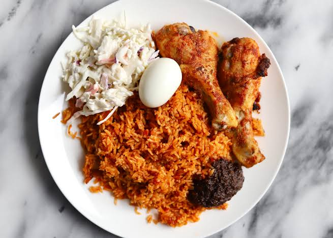 Jollof Rice stands at the heart of Nigerian cuisine. It’s one of the most popular dishes in West Africa, known for its vibrant color and rich flavor