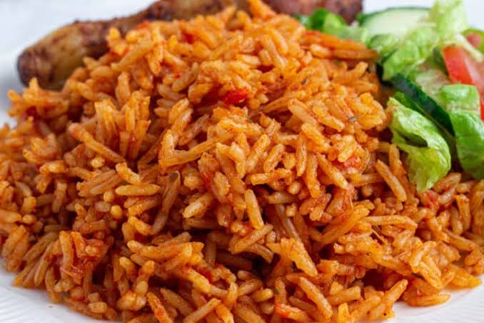 Jollof Rice stands at the heart of Nigerian cuisine. It’s one of the most popular dishes in West Africa, known for its vibrant color and rich flavor