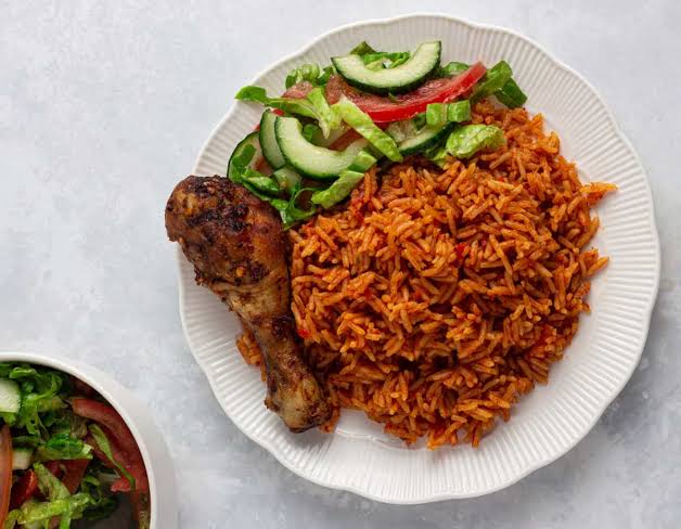 Jollof Rice stands at the heart of Nigerian cuisine. It’s one of the most popular dishes in West Africa, known for its vibrant color and rich flavor